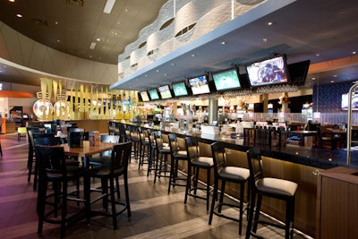 The bar at Dave & Buster's is adjacent to the venue's 'Million Dollar Midway' of games, but is quiet enough that guests can enjoy watching sports on one of the 17 TVs.
