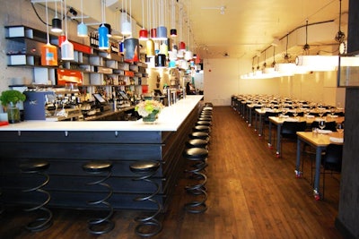 Recycled fire extinguishers illuminate the 30-foot-long bar on the upper level of Parts & Labour.