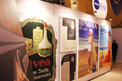 A wall covered with ads in English, German, and Italian shows the evolution of Nivea as a brand and its global reach.