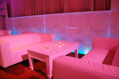 White sofas and tables lined the Artifacts Room. Panels of glass covered the walls, illuminated by colourful lights.
