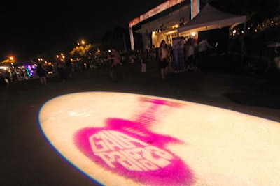 A gobo of the event's name in a purple guitar lit up the pavement in front of the stage.