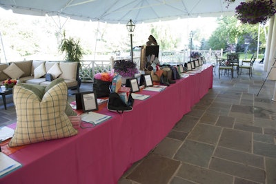 Draped in bright pink linens, the silent auction tables ran down the center of the terrace.