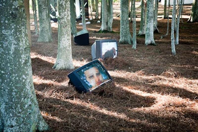 In another section, televisions rested against tree trunks and played silent solemn Spanish soap operas.