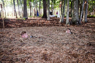 Performance artist Ryan McNamara's piece included him and a fellow performer buried in a sea of wood and pine needles. Microphones lay near their mouths, where they crooned the love song 'Up Where We Belong.'