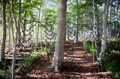 Vladimir von Arx's installation, 'Die Spinnen Werden Verrückter und Verrückter' ('The Spiders Get Crazy and More Crazy'), served as an entryway for guests moving among the live art installations. It was a double gate cobweb made of clothes hangers, created on site at Watermill.