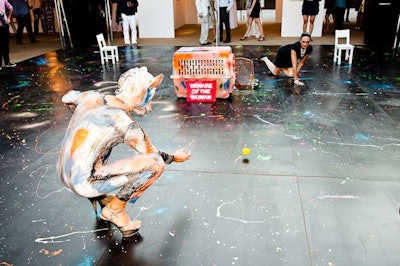 'Be Aware of the Woman,' a work by Atopos Contemporary Visual Culture and Charlie Le Mindu, was designed to speak to sexuality and role reversal between a secretary and a dog, the latter dressed in a Latex suit as a nod to S&M style. The duo performed on a paint-splattered dance floor done by Megan Whitmarsh.