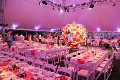 For the dinner portion of the event, 650 guests descended a flight of stairs into a massive white tent. The centerpiece of the structure was a gigantic chandelier bedecked with hundreds of ornate balloons.
