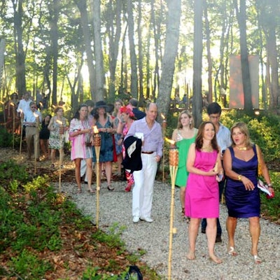Torches lined the path into the Watermill Center's forest, guiding guests to more live exhibits and providing mosquito-repelling smoke.