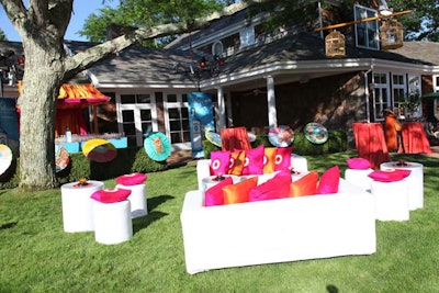 The East Hampton estate of Rush Philanthropic founder Russell Simmons served as the site for the Art for Life benefit. Paper parasols painted by youth from the Rush Kids programs decorated the lawn for the cocktail reception, adding a splash of color to the hedges. The designs were inspired by a field trip to Chinatown.