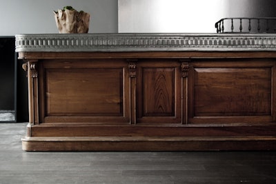 An antique pewter and walnut bar is portable and can be stationed throughout the space. The venue serves wine, champagne, and specialty cocktails.