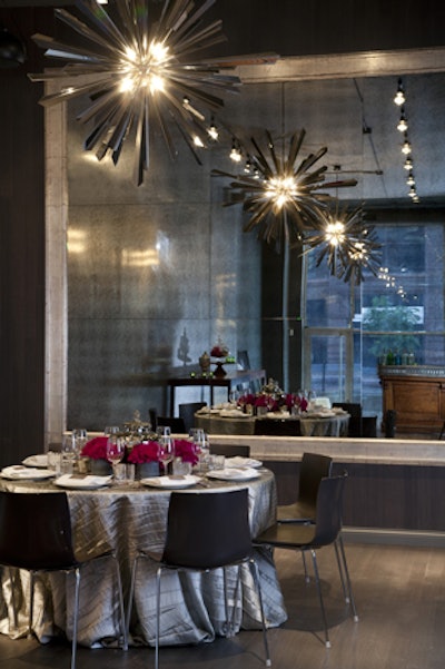 Decorations include an antiqued mirror along the back wall and sunburst-shaped light fixtures.