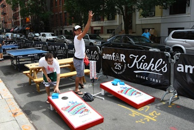 A beanbag toss area on East 13th Street in New York had boards branded with Kiehl's LifeRide for Amfar imagery.