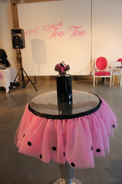 As a nod to the perfume's name, Too Too, the production team added tutus to the event's cocktail tables. The scent's graffiti-style graphics adorned white walls, which separated the event space from the backstage area for the dancers.