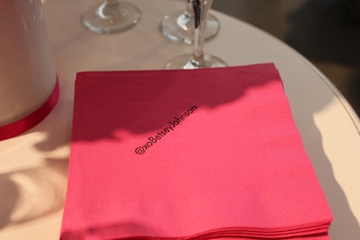 As a subtle way to encourage attendees to promote the event on social media platforms, the pink napkins at the event were printed with Johnson's official Twitter username, @xoBetseyJohnson.
