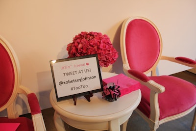 Pink velvet armchairs and tufted white leather daybeds dotted around the space underscored the girly look of the event, and provided places for guests to sit and eat.