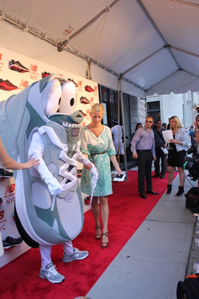 On hand to welcome guests�'including model Molly Sims, Captain America lead Chris Evans, and singer Katharine McPhee�'was a staffer dressed as a giant New Balance running shoe. Naturally, the actor wore New Balance sneakers on his feet.