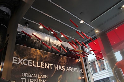 Above the photo booth, an installation of batons is part of the store's decor.