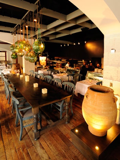 Artful glass fishing floats hang above the communal table, which seats 12.