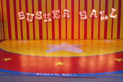 Red and yellow stripes covered the backdrop for the indoor stage.