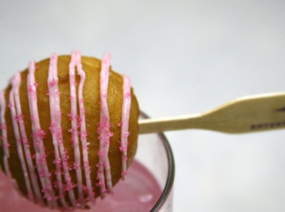 Entertaining Company consistently creates new cocktails with unusual garnishes. New on the beverage list is a blend of vodka, ginger ale, and pink lemonade topped with a doughnut hole stuffed with mascarpone mousse. Pink frosting and sprinkles top it all off.
