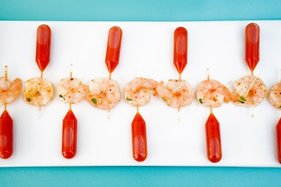 Suited for brunches or lunchtime events, Boutique Bites' Bloody Mary pipettes include shrimp, which the guests eat before squeezing the spicy cocktails into their mouths from the pipettes.