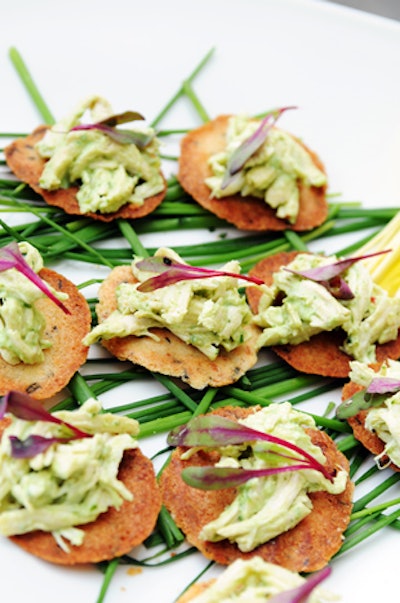 A La Carte Catering & Event Design’s fall lineup includes a lemongrass and ginger poached chicken hors d’oeuvre dressed in a house-made basil yogurt coulis. The bites are served on black sesame seed tuiles with micro greens.