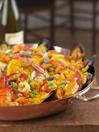 In response to clients looking to move away from a traditional entrée plate of a protein, starch, and vegetable, Susan Gage Caterers’ Spanish sous chef Paco Cozar has helped perfect a traditional seafood and chicken paella this fall. The dish includes ingredients like saffron, red peppers, calamari, octopus, shrimp, and chicken and can be served either family-style in a pan or plated.