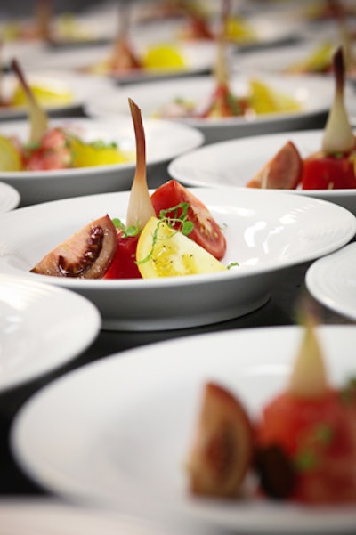 The Oliver & Bonacini events menu offers a fresh and flavourful salad of heirloom tomatoes and compressed watermelon served with pickled ramps, radish crudités, and basil cress and finished with a vincotto drizzle.