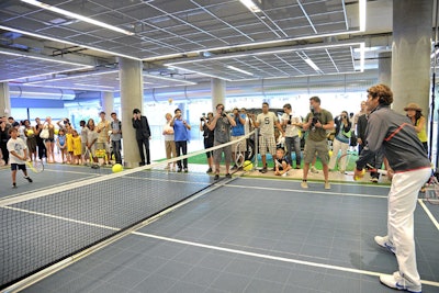 In addition to signing tennis balls and giving away tickets at Mercedes-Benz Manhattan, Federer played tennis with fans in a court inside the dealership.