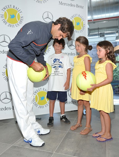 Eager sports fans, who discovered the time and location of the giveaway from Mercedes-Benz U.S.A.'s Twitter account at 6:30 a.m. that morning, got a chance to meet Federer and have him autograph items.