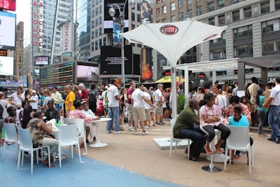 Behind the fleet of cars, the promotion offered an alfreso café-like setting, replete with white and red chairs, tables, and branded umbrellas.