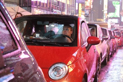 Despite Sunday's rainy weather, Fiat kept the promotion going and passersby were only too happy to sit inside the cars to get out of the downpour.