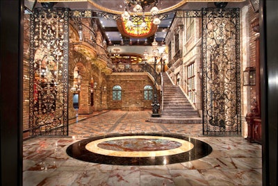 The grand staircase courtyard has natural onyx stone floors and iron and brass sculpted gates.