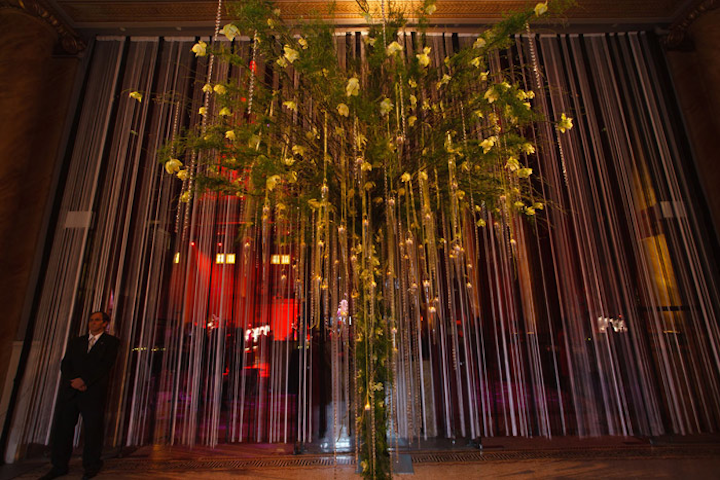 In the lobby of Capitale, Cowie installed a full-size tree and covered it with orchid stems, ribbon, and strands of crystals.