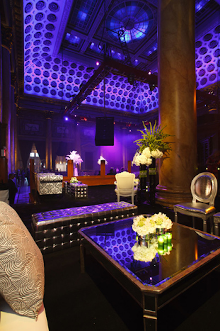 The V.I.P. areas stood on elevated platforms and featured white floral arrangements, plenty of lounge furniture, and green votives.