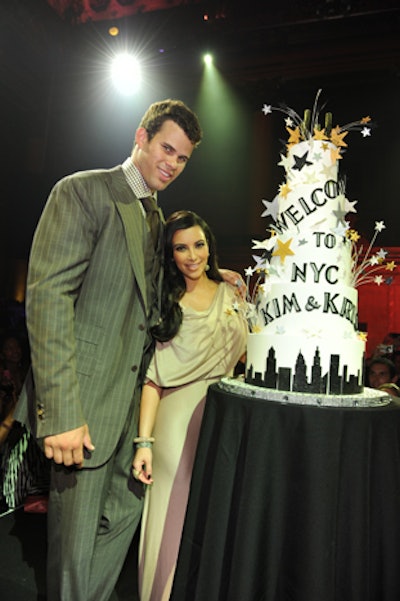 An elaborate tiered cake topped with sparklers was presented on stage and Kim Kardashian and Kris Humphries were brought out to cut the confection.