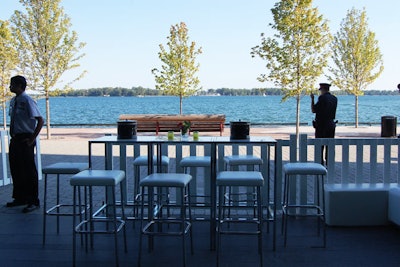 Corus's patio overlooked Lake Ontario. White tables, stools, and couches added to the beach feel.