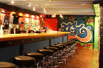 The Black Squirrel's new tap room is decorated with graffiti images on the walls and 50 black leather stools at its expansive bar.
