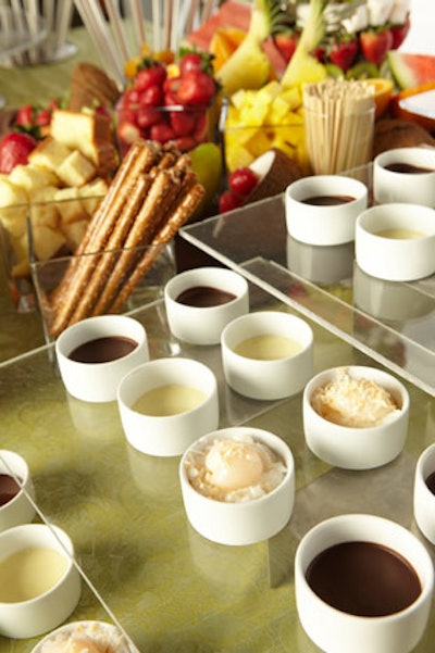 For a promotional party in New York, Thomas Preti Caterers served individual fondue cups filled with warm chocolate sauces, with items like marshmallows, kiwi slices, and strawberries to dip.