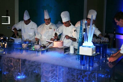 Staffers from Spencer’s for Steaks and Chops at the Hilton Orlando serve cherry and Coca-Cola floats topped with frozen brandy drops, dark chocolate cake soaked with Coca-Cola, and sour cherry mousse at a dessert station that used nitrogen to freeze ingredients.