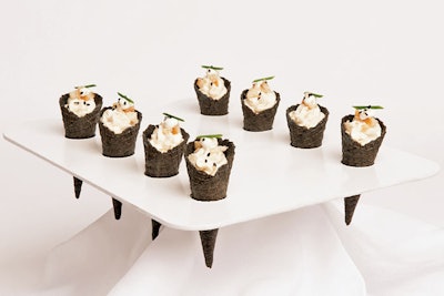 “The menu is both indulgent and appropriately seaworthy, with squid ink cones filled with smoked trout and sesame-scented crème fraîche.” Hors d’oeuvres by Paramount Events