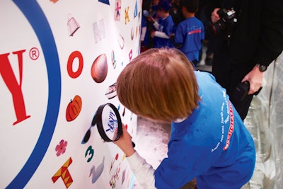 Scholastic’s 20th anniversary I Spy event in Times Square in April included a scavenger hunt for 20 second-graders to find objects hidden on the exterior of a larger-than-life cake-shaped structure.