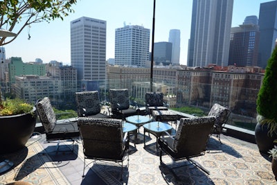 Outside, iron dining furniture complements wicker lounge pieces.