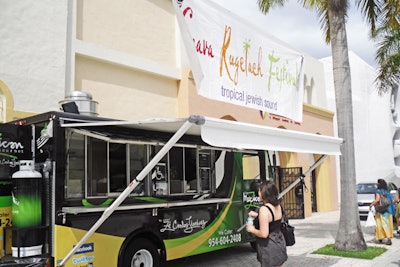 Chef Ze Carlos Jimenez's MexZican Gourmet truck parked outside the Temple Israel of Greater Miami, offering menu items to daytime guests of the festival.