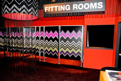 Black string forms a sheer fringe wall between the store and the dressing rooms. Target's bull's-eye logo, in classic Missoni colors, is projected onto a solid-colored rug, and four enormous lampshades featuring the Italian fashion house's signature pattern hang from the ceiling.