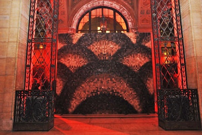 Impressively detailed, the wall at the main entrance to the building's hall was a mosaic of nearly 14,000 two-inch blocks milled from reclaimed oak. Retail display design studio Burke & Pryde helped fashion the piece, pixelating the design and reducing it to five shades of brown. Workers then assembled the 14-foot-wide and 12-foot-tall structure following a grid broken into two- and four-foot sections.