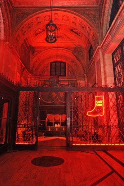 In a caged area beside the main doors, the Frye Company set up a shoe shine area marked by a red neon sign in the shape of a boot.