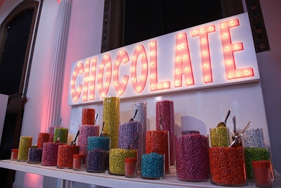A colorful candy bar offered ET-logo M&Ms from glass vessels of varying heights.