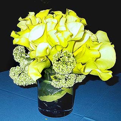 Florist Mille Fiori provided simple vases of yellow mini calla lilies for the tables.