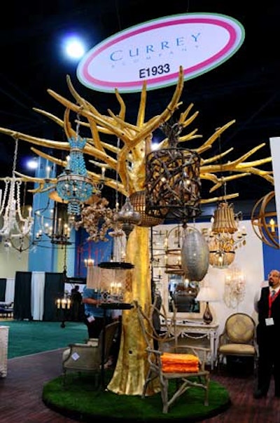 Currey & Company showcased its unique chandelier and lighting product by hanging several of them from a tree in the center of their booth.